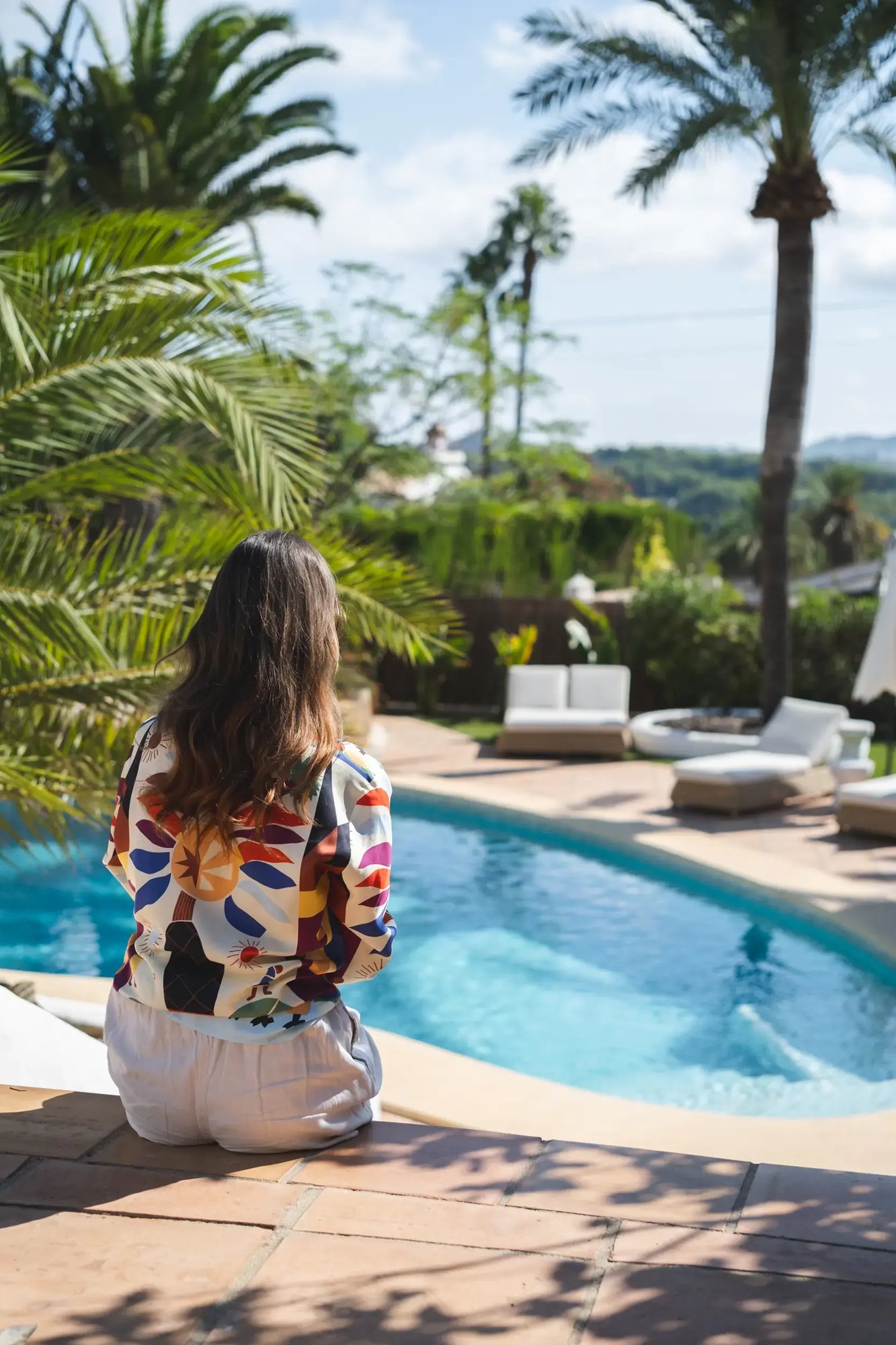 woman-sitting-by-pool
